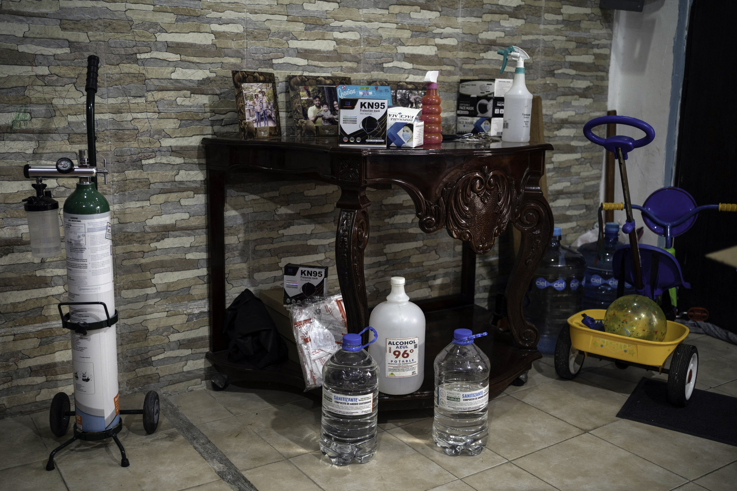 Different products to prevent the spread of Covid 19 remain at the house of Cesar Augusto Fernandez, who died of Covid-19 after being infected working in an oil tanker, in Veracruz, Mexico on August 23, 2021. - With just days to go before school restarts in Mexico, Andrea Montero, mother of three children shaken by the sudden death of their father from covid-19, has made up her mind: her children will not attend school in person. (Photo by VICTORIA RAZO / AFP)