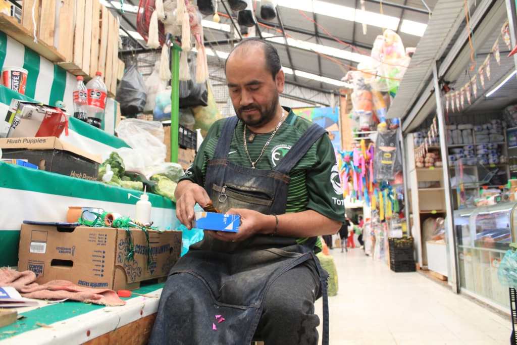 Carlos Felipe elaborando piñata miniatura en el mercado 16 de septiembre