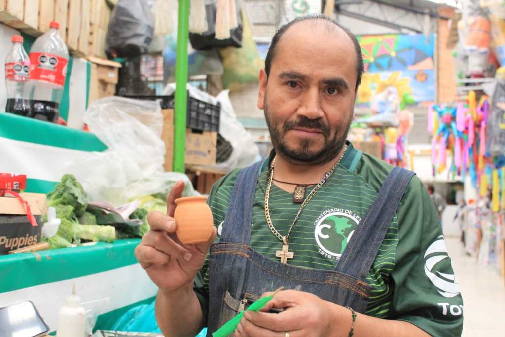 Carlos Felipe elaborando piñata miniatura en el mercado 16 de septiembre