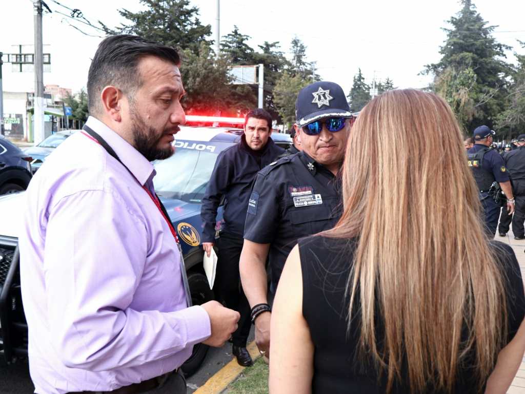 Funcionarios locales y policías conversan durante un operativo de clausura de un bar en Toluca, donde se reportó consumo de alcohol por jóvenes.