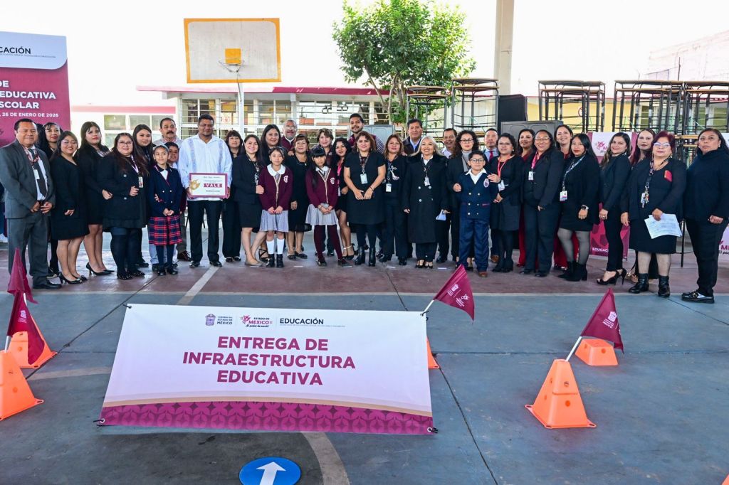 A group of educators and students gathered at a school ceremony, celebrating the delivery of educational infrastructure. A banner reading 'ENTREGA DE INFRAESTRUCTURA EDUCATIVA' is prominently displayed in the foreground.