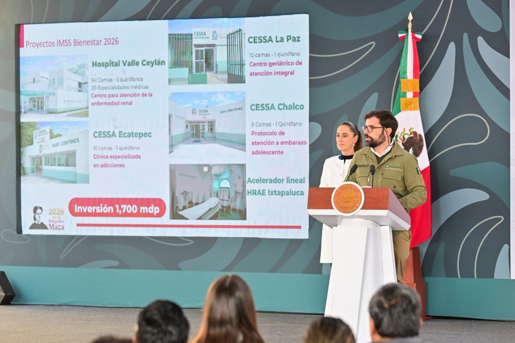 A presentation showcasing healthcare projects for IMSS Bienestar 2026, featuring various medical facilities and services, with two speakers at a podium and a Mexican flag in the background.
