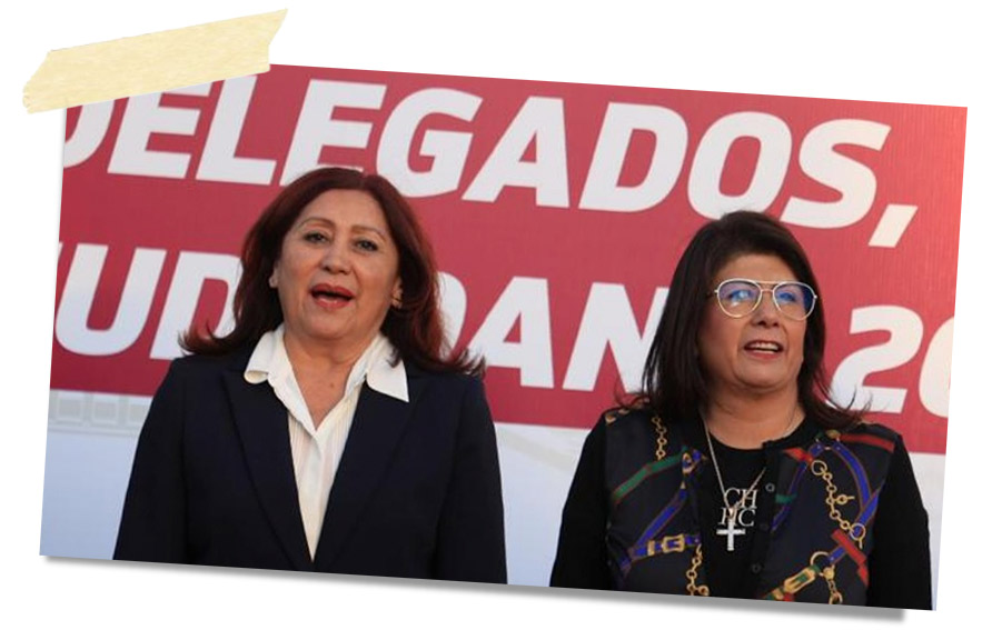 Dos mujeres sonrientes en un evento, con un fondo que dice 'DELEGADOS, NUDANDOS, 2023'.
