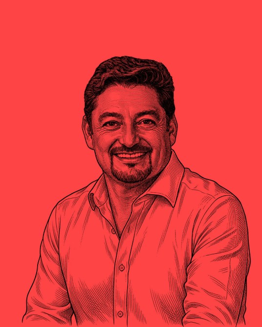 A digital illustration of a smiling man with medium-length dark hair, wearing a collared shirt, against a bright red background.