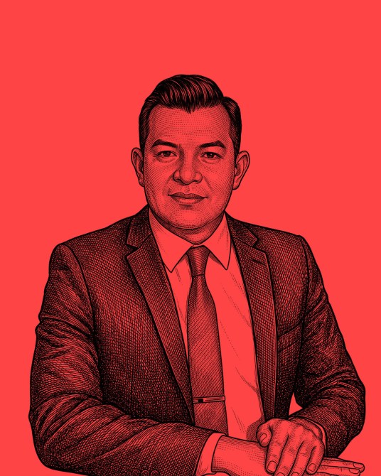 A digital illustration of a man in a suit with short hair, sitting at a table against a bright red background, looking confidently at the viewer.